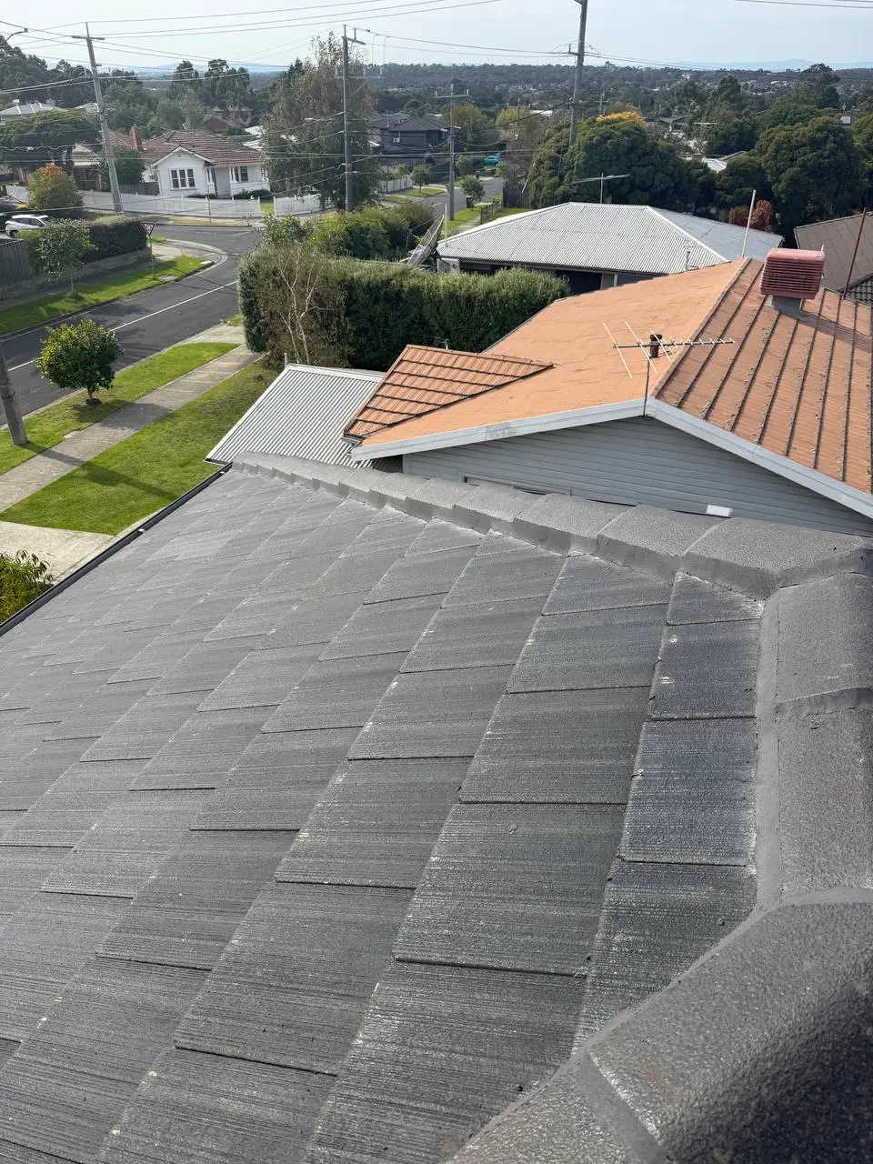 Weathered tile roof with cracked ridge pointing and moss, before repair — project 4